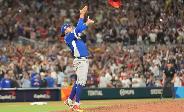 Venezuela pitcher Daniel Palencia celebrates after the team defeated the United States in the championship game of the World Baseball Classic, Tuesday, March 17, 2026, in Miami. (AP Photo/Rebecca Blackwell)