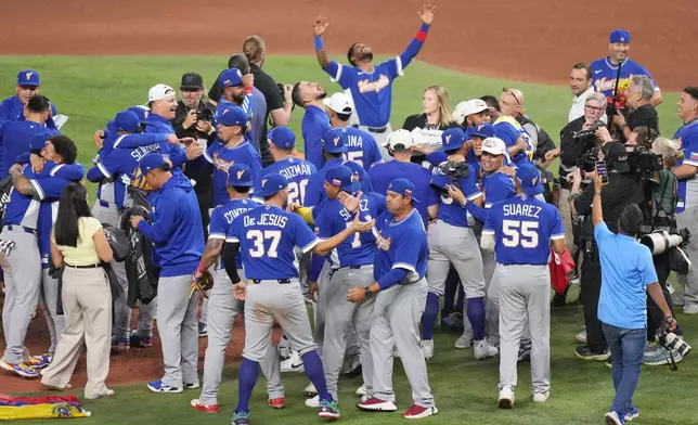 The Venezuela team celebrates after defeating the United States in the championship game of the World Baseball Classic, Tuesday, March 17, 2026, in Miami. (AP Photo/Lynne Sladky)