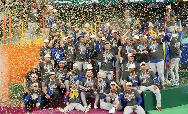 The Venezuela team celebrates after defeating the United States in the championship game of the World Baseball Classic, Tuesday, March 17, 2026, in Miami. (AP Photo/Rebecca Blackwell)