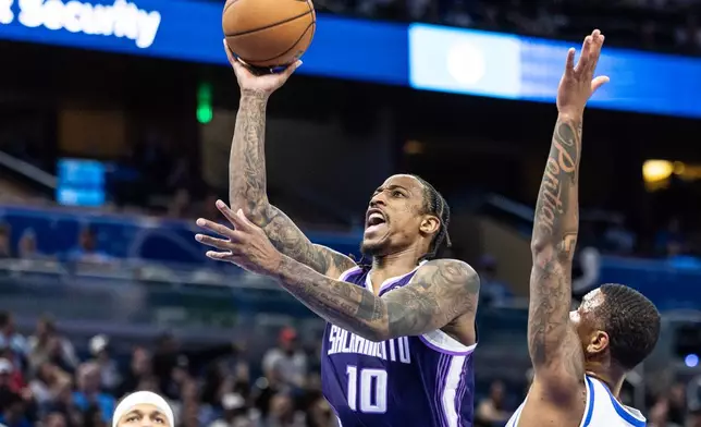 Sacramento Kings guard DeMar DeRozan (10) looks to shoot against Orlando Magic forward Jamal Cain (8) during the first half of an NBA basketball game, Thursday, March 26, 2026, in Orlando, Fla. (AP Photo/Willie J. Allen Jr.)