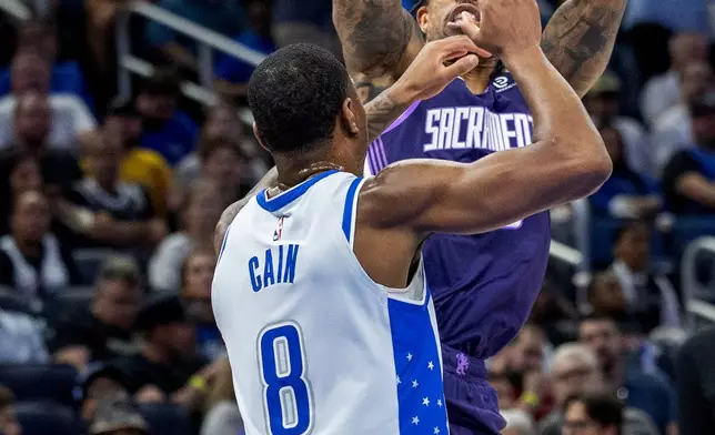 Sacramento Kings guard/forward DeMar DeRozan (10) shoots over Orlando Magic forward Jamal Cain (8) during the first half of an NBA basketball game, Thursday, March 26, 2026, in Orlando, Fla. (AP Photo/Willie J. Allen Jr.)