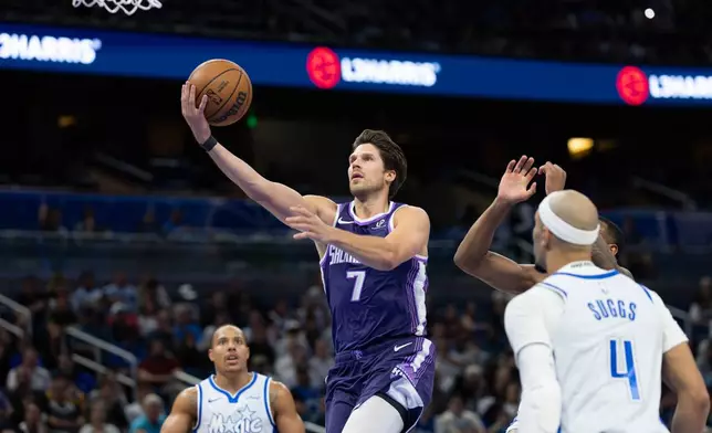 Sacramento Kings forward Doug McDermott (7) lays the ball up during the first half of an NBA basketball game, against the Orlando Magic, Thursday, March 26, 2026, in Orlando, Fla. (AP Photo/Willie J. Allen Jr.)
