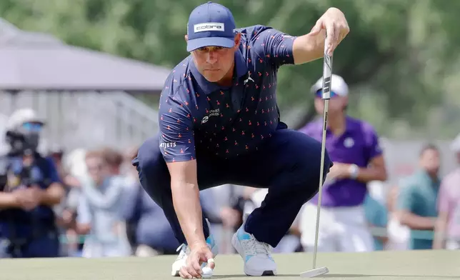 Gary Woodland places his ball on the ninth green during the final round of the Texas Children's Houston Open golf tournament Sunday, March 29, 2026, in Houston. (AP Photo/Michael Wyke)