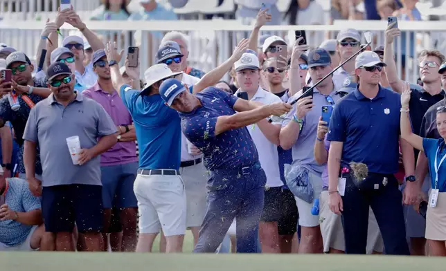 Gary Woodland hits on the 18th fairway next to the gallery during the final round of the Texas Children's Houston Open golf tournament Sunday, March 29, 2026, in Houston. (AP Photo/Michael Wyke)