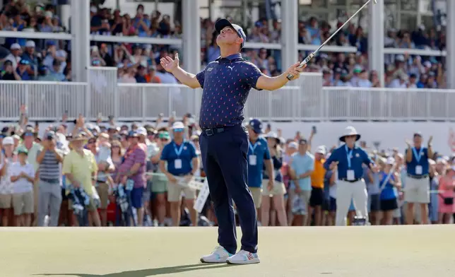 Gary Woodland celebrates after sinking his final putt on the 18th green to win the Texas Children's Houston Open golf tournament Sunday, March 29, 2026, in Houston. (AP Photo/Michael Wyke)