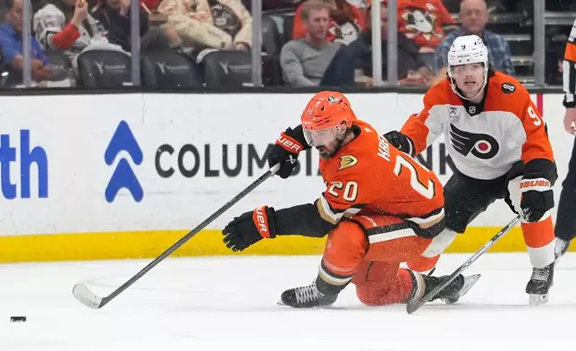 Anaheim Ducks left wing Chris Kreider, left, falls while under pressure from Philadelphia Flyers defenseman Jamie Drysdale during the second period of an NHL hockey game Wednesday, March 18, 2026, in Anaheim, Calif. (AP Photo/Mark J. Terrill)