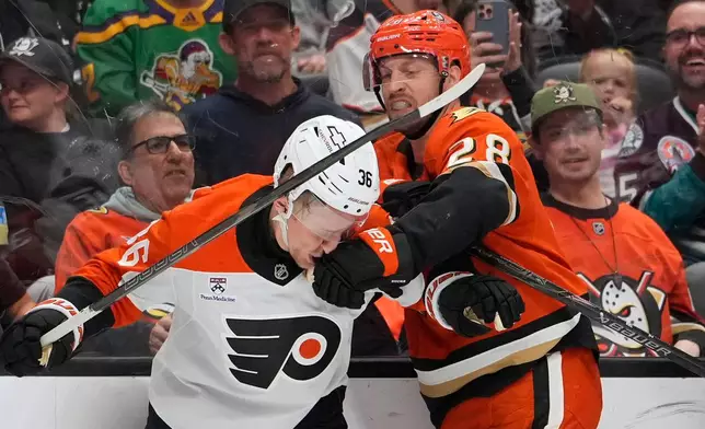 Anaheim Ducks left wing Jeffrey Viel, right, punches Philadelphia Flyers defenseman Emil Andrae during the second period of an NHL hockey game Wednesday, March 18, 2026, in Anaheim, Calif. (AP Photo/Mark J. Terrill)