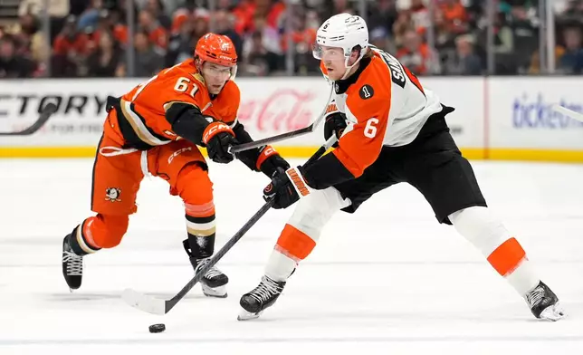 Anaheim Ducks left wing Cutter Gauthier, left, high sticks Philadelphia Flyers defenseman Travis Sanheim during the second period of an NHL hockey game Wednesday, March 18, 2026, in Anaheim, Calif. (AP Photo/Mark J. Terrill)