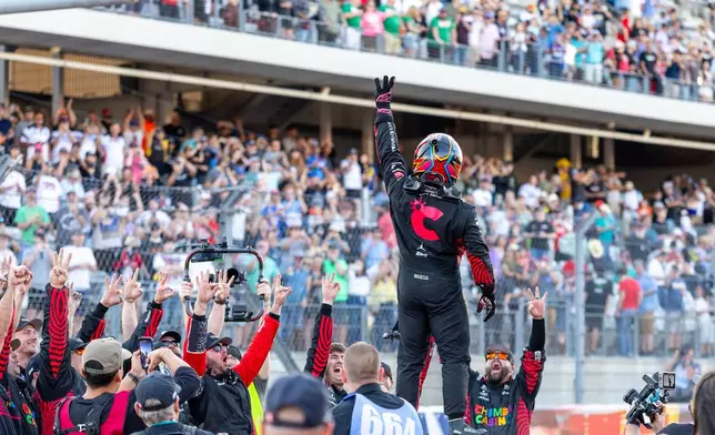 23XI Racing's Tyler Reddick, center, celebrates his win during a NASCAR Cup Series auto race in Austin, Texas, Sunday, March 1, 2026. (AP Photo/Stephen Spillman)