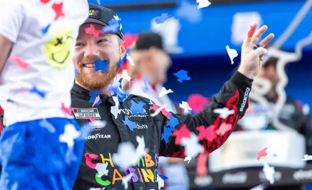 23XI Racing's Tyler Reddick, right, celebrates with his son Beau Reddick, left, after winning a NASCAR Cup Series auto race in Austin, Texas, Sunday, March 1, 2026. (AP Photo/Stephen Spillman)