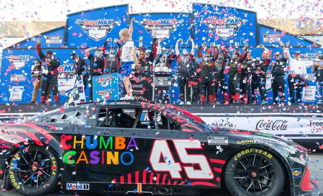 23XI Racing's Tyler Reddick, front right, celebrates with his son Beau Reddick, front left, after winning a NASCAR Cup Series auto race in Austin, Texas, Sunday, March 1, 2026. (AP Photo/Stephen Spillman)