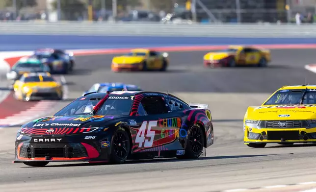 23XI Racing's Tyler Reddick (45) and Team Penske's Ryan Blaney drive through Turn 13 during a NASCAR Cup Series auto race in Austin, Texas, Sunday, March 1, 2026. (AP Photo/Stephen Spillman)