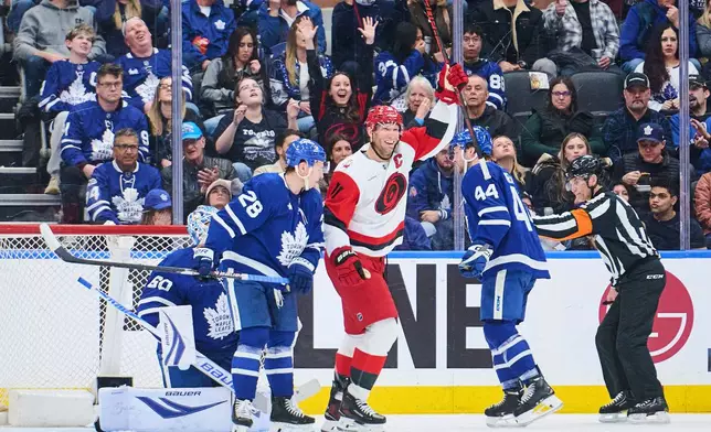 Carolina Hurricanes' Jordan Staal (11) celebrates after scoring against the Toronto Maple Leafs during second-period NHL hockey game action in Toronto, Friday, March 20, 2026. (Sammy Kogan/The Canadian Press via AP)