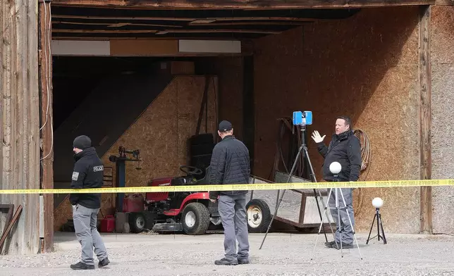 Authorities conduct an investigation at a home where a woman was found dead in Lyman, Utah, Thursday, March 5, 2026. (AP Photo/George Frey)