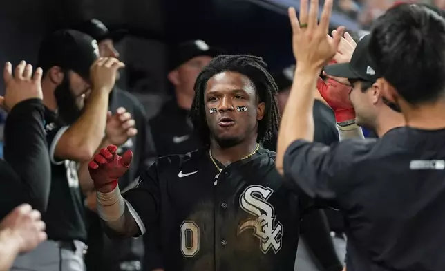 Chicago White Sox Luisangel Acuna (0) celebrates after scoring in the sixth inning during a baseball game against the Miami Marlins Monday, March 30, 2026, in Miami. (AP Photo/Marta Lavandier)
