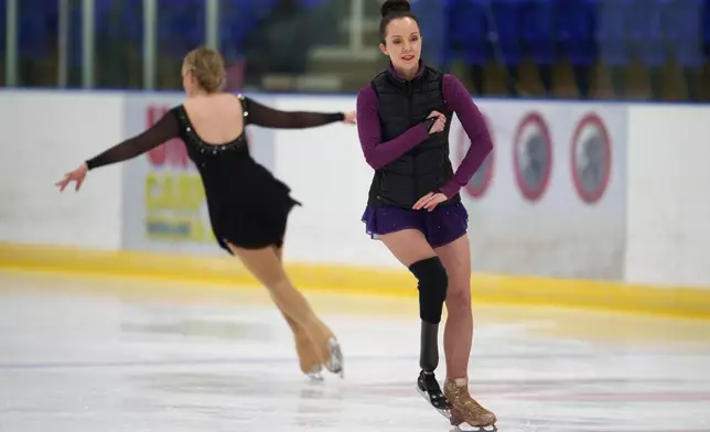 Stef Reid, a former Paralympic athlete who now does figure skating, warmes up before competing in the British Adult Figure Skating Championships in Sheffield, England, Friday, Feb. 6, 2026. (AP Photo/Jon Super)