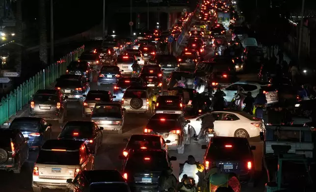 Cars sit in traffic as residents flee Israeli airstrikes in Dahiyeh, a southern suburb of Beirut, Lebanon, early Monday, March 2, 2026. (AP Photo/Bilal Hussein)