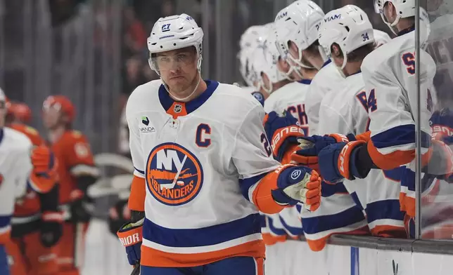 New York Islanders left wing Anders Lee celebrates his goal with teammates during the first period of an NHL hockey game against the Anaheim Ducks Wednesday, March 4, 2026, in Anaheim, Calif. (AP Photo/Gregory Bull)