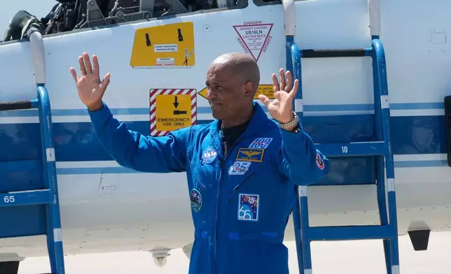 Artemis 2 crew member, Pilot Victor Glover, waves to the media after the crew's arrival at the Kennedy Space Center Friday, March 27, 2026, in Cape Canaveral, Fla. (AP Photo/Chris O'Meara)