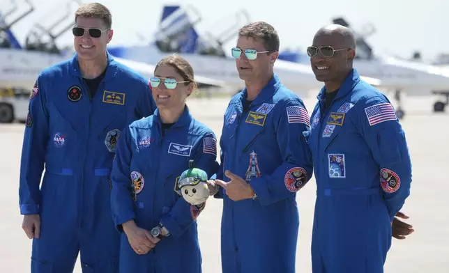 Artemis 2 crew members, from left, Mission Spc. Jeremy Hansen, of Canada, Mission Spc. Christina Koch, Commander Reid Wiseman, and Pilot Victor Glover pose for a photo after the crew's arrival at the Kennedy Space Center Friday, March 27, 2026, in Cape Canaveral, Fla. (AP Photo/Chris O'Meara)