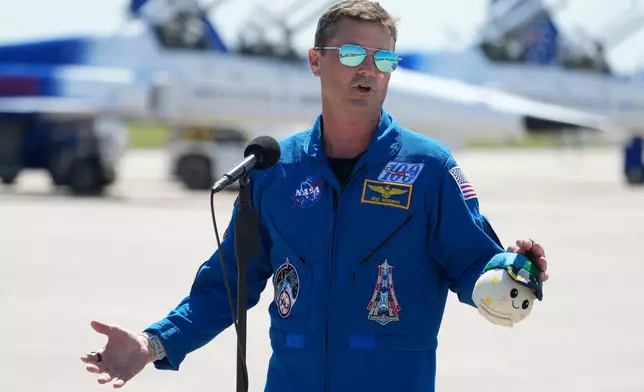 Artemis 2 Commander Reid Wiseman speaks to the media after the crew's arrival at the Kennedy Space Center, Friday, March 27, 2026, in Cape Canaveral, Fla. (AP Photo/Chris O'Meara)