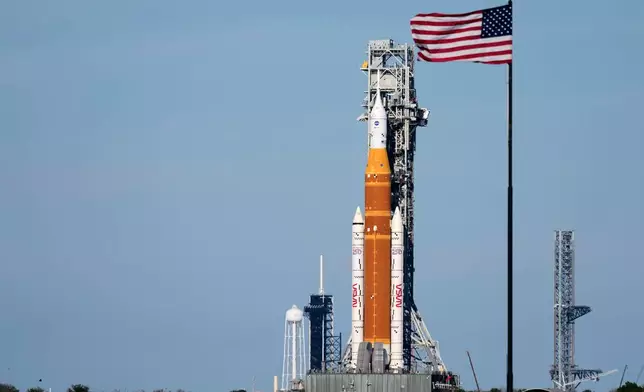 FILE - NASA's Artemis II SLS (Space Launch System) moon rocket with the Orion spacecraft slowly rolls back towards the Vehicle Assembly Building at the Kennedy Space Center, Feb. 25, 2026, in Cape Canaveral, Fla. (AP Photo/John Raoux, File