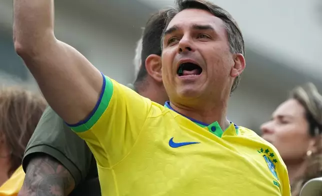 Sen. Flavio Bolsonaro, son of former President Jair Bolsonaro and a candidate in Brazil's October presidential election, gestures to supporters during a protest against President Luiz Inacio Lula da Silva in Sao Paulo, Sunday, March 1, 2026. (AP Photo/Andre Penner)