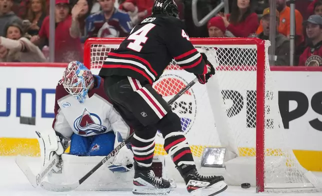 Chicago Blackhawks defenseman Wyatt Kaiser (44), right, scores on Colorado Avalanche goaltender MacKenzie Blackwood (39) during the second period of an NHL hockey game Friday, March 20, 2026, in Chicago. (AP Photo/Erin Hooley)