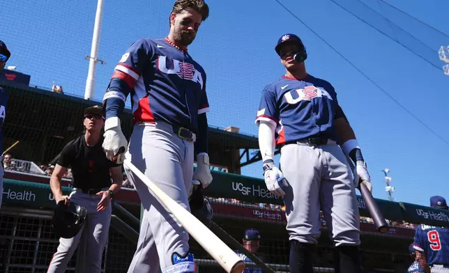 United States' Aaron Judge, right, and Bryce Harper wait to bat prior to an exhibition baseball game against the San Francisco Giants Tuesday, March 3, 2026, in Scottsdale, Ariz. (AP Photo/Ross D. Franklin)