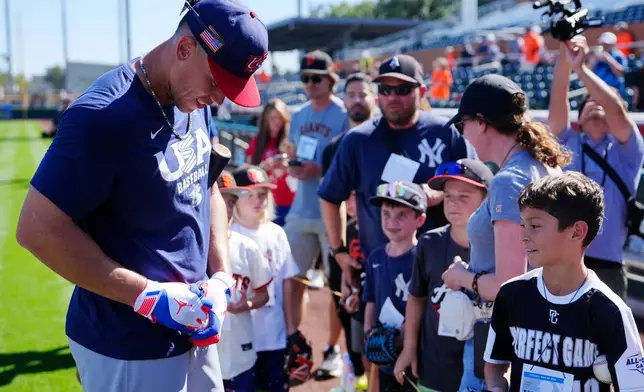 United States' Aaron Judge signs autographs prior to an exhibition baseball game against the San Francisco Giants Tuesday, March 3, 2026, in Scottsdale, Ariz. (AP Photo/Ross D. Franklin)