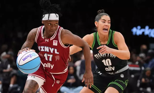 Vinyl BC guard Erica Wheeler (17) drives past Phantom BC guard Kelsey Plum (10) during the first half of a semifinal in their Unrivaled 3-on-3 basketball game, Monday, March 2, 2026, in New York. (AP Photo/Frank Franklin II)
