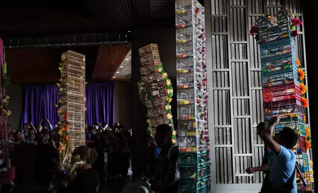 Bird sellers with his decorated cages enter the Basilica of Guadalupe during their annual pilgrimage in Mexico City, Sunday, March 29, 2026. (AP Photo/Eduardo Verdugo)