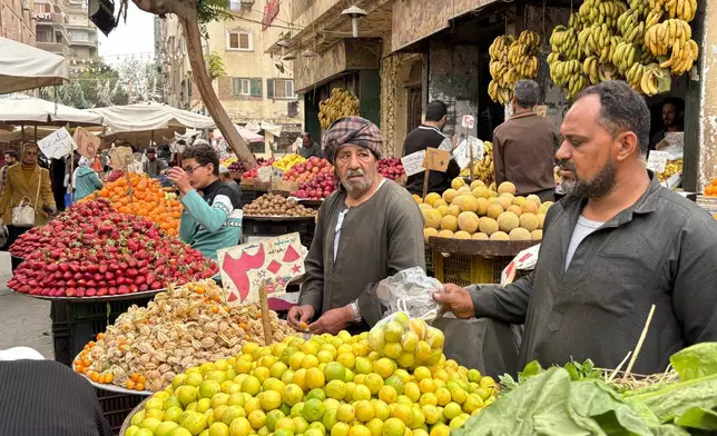 Vendors line up at a popular market in Cairo, Egypt, Tuesday, March 12, 2026. (AP Photo/Amr Nabil)