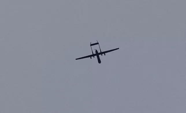 An Israeli drone flies over the southern port city of Tyre, Lebanon, Saturday, March 28, 2026. (AP Photo/Hussein Malla)