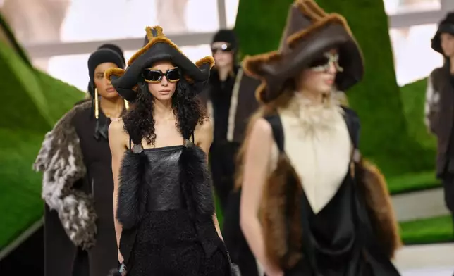 Models wear creations from the Louis Vuitton Fall/Winter 2026-2027 Women's collection presented in Paris, Tuesday, March 10, 2026. (AP Photo/Aurelien Morissard)