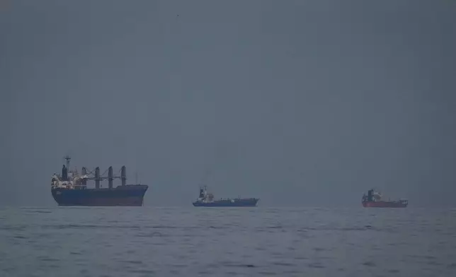 Oil tankers and ships line up in the Strait of Hormuz as seen from Khor Fakkan, United Arab Emirates, Wednesday, March 11, 2026. (AP Photo/Altaf Qadri)