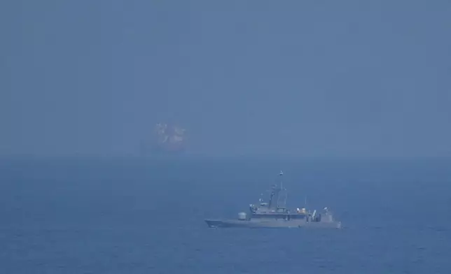 A UAE navy ship patrols the Strait of Hormuz as seen from Mina Al Fajer, United Arab Emirates, Wednesday, March 11, 2026. (AP Photo/Altaf Qadri)