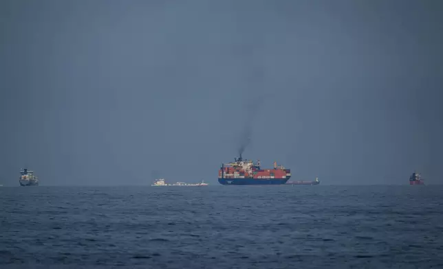 Oil tankers and cargo ships line up in the Strait of Hormuz as seen from Khor Fakkan, United Arab Emirates, Wednesday, March 11, 2026. (AP Photo/Altaf Qadri)