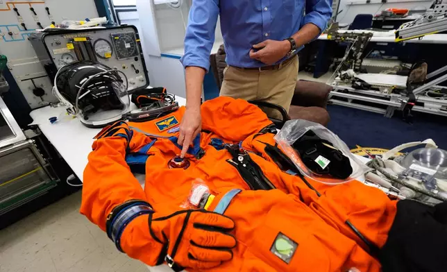 Dustin Gohmert, Orion Crew Survival Systems project manager, describes construction of space suits that will be used for the Artemis II mission at Johnson Space Center on Thursday, July 24, 2025, in Houston. (AP Photo/Ashley Landis)