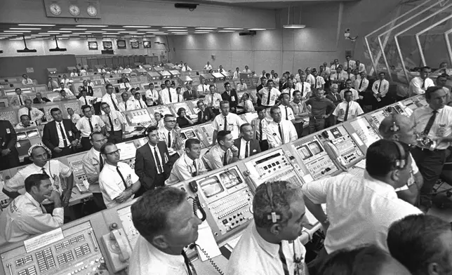 FILE - In this photo provided by NASA, JoAnn Morgan, sitting in the center of the third row, watches the launch of Apollo 11 from the launch firing room, July 16, 1969, in Cape Canaveral, Fla. (NASA via AP, File)