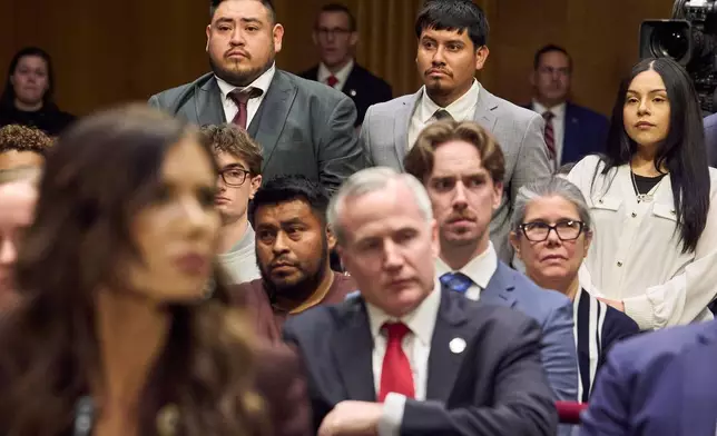 FILE - Homeland Security Secretary Kristi Noem, front left, listens as three U.S. citizens who had been detained by ICE stand, from back left, Javier Ramirez, of Calif., Leonardo "Leo" Garcia Venegas, of Ala., and Marimar Martinez, of Chicago, as they are introduced by Sen. Richard Blumenthal, D-Ct., during an oversight hearing before the Senate Judiciary Committee, on Capitol Hill in Washington, March 3, 2026. (AP Photo/Jacquelyn Martin, File)