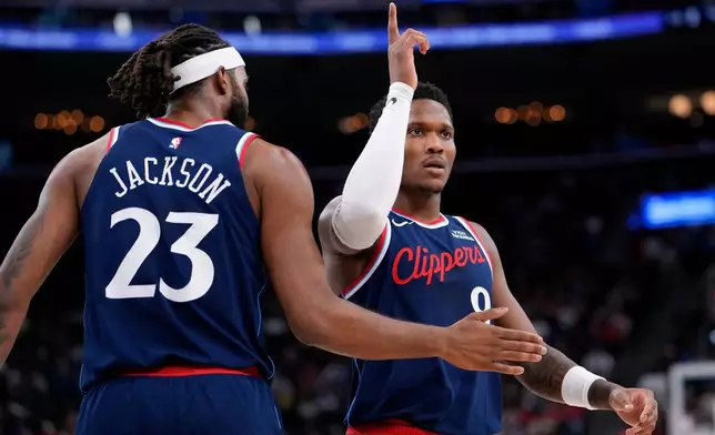 Los Angeles Clippers guard Bennedict Mathurin, right, celebrates with forward Isaiah Jackson after scoring during the first half of an NBA basketball game against the Toronto Raptors, Wednesday, March 25, 2026, in Inglewood, Calif. (AP Photo/Mark J. Terrill)