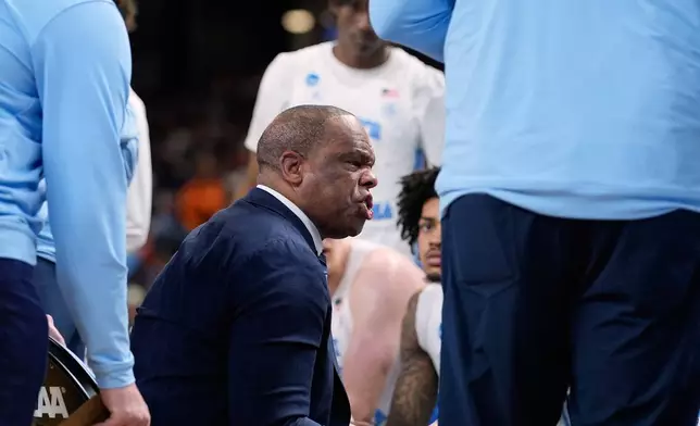 North Carolina head coach Hubert Davis talks with his team during the second half in the first round of the NCAA college basketball tournament against Virginia Commonwealth, Thursday, March 19, 2026, in Greenville, S.C. (AP Photo/Brynn Anderson)