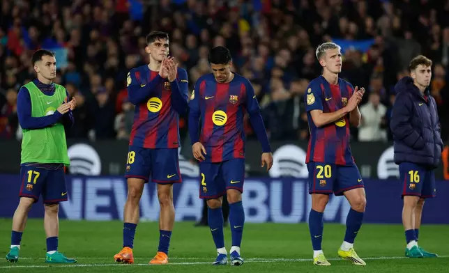Barcelona's Marc Casado, from left, Gerard Martin, Joao Cancelo, Dani Olmo and Fermin Lopez react after the Copa del Rey semifinal second leg soccer match between Barcelona and Atletico Madrid in Barcelona, Spain, Tuesday, March 3, 2026. (AP Photo/Joan Monfort)