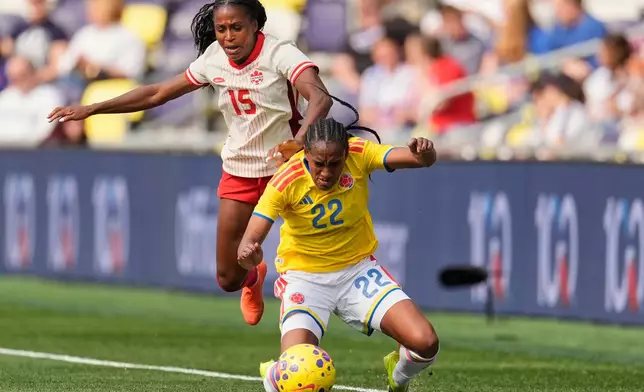 Canada forward Nichelle Prince (15) pushes Colombia defender Daniela Caracas (22) to the ground during the second half of a SheBelieves Cup women's soccer tournament match Sunday, March 1, 2026, in Nashville, Tenn. (AP Photo/George Walker IV)