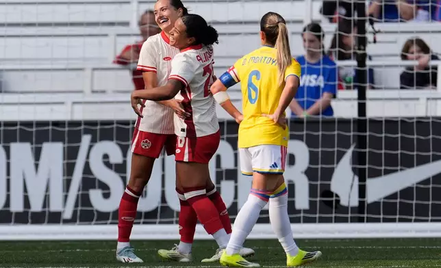 Canada defender Sydney Collins, left, celebrates her goal with midfielder Marie-Yasmine Alidou, center, during the second half of a SheBelieves Cup women's soccer tournament match Sunday, March 1, 2026, in Nashville, Tenn. (AP Photo/George Walker IV)