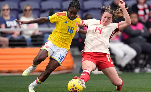 Canada defender Vanessa Gilles (14) kicks the ball away from Colombia midfielder Linda Caicedo (18) during the second half of a SheBelieves Cup women's soccer tournament match Sunday, March 1, 2026, in Nashville, Tenn. (AP Photo/George Walker IV)
