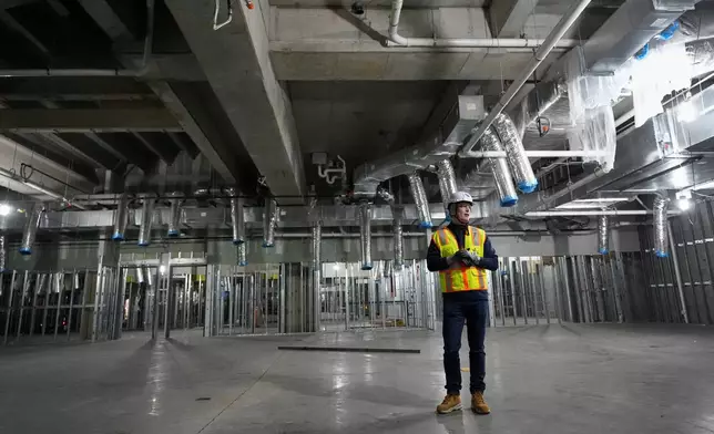 Tennessee Titans president Burke Nihill leads a construction tour of the NFL football team's new enclosed stadium Tuesday, March 24, 2026, in Nashville, Tenn. (AP Photo/George Walker IV)