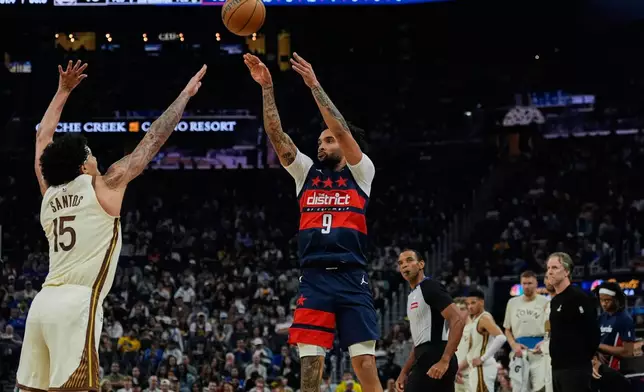 Washington Wizards forward Justin Champagnie (9) shoots a 3-point basket over Golden State Warriors forward Gui Santos (15) during the first half of an NBA basketball game, Friday, March 27, 2026, in San Francisco. (AP Photo/Godofredo A. Vásquez)