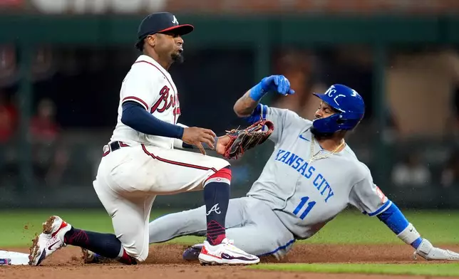 Kansas City Royals' Maikel Garcia (11) steals the base against Atlanta Braves second baseman Ozzie Albies (1) during the third inning of an opening-day baseball game, Friday, March 27, 2026, in Atlanta. (AP Photo/Mike Stewart)